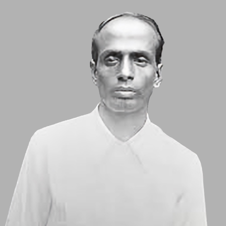 Monochrome portrait study of Surya Sen, head and shoulders, isolated against a plain grey ground.